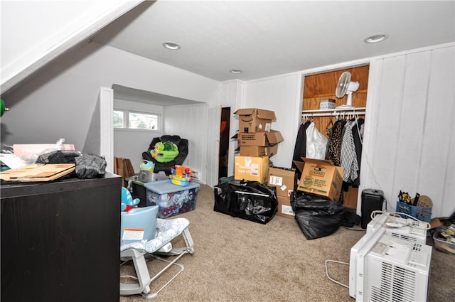 carpeted bedroom with a closet and lofted ceiling