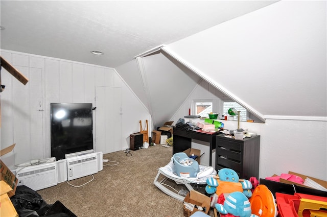 additional living space featuring a wall mounted AC, carpet flooring, and lofted ceiling