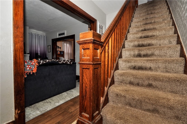 stairway featuring hardwood / wood-style floors