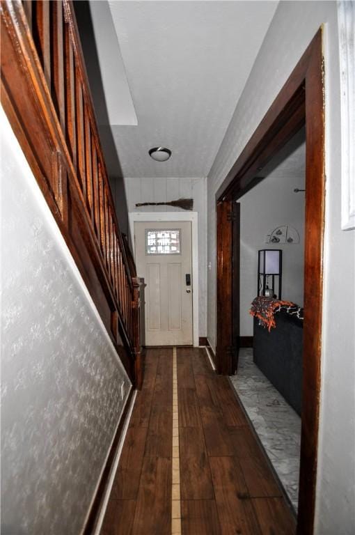 doorway to outside with dark wood-type flooring and stairway