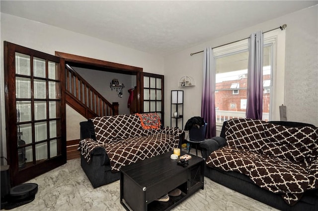 living room with marble finish floors and stairway