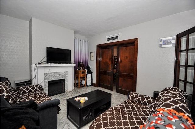 living room with a stone fireplace and light colored carpet