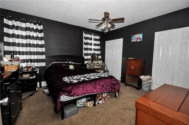 bedroom featuring carpet, multiple closets, and ceiling fan