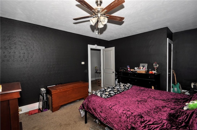 carpeted bedroom featuring a textured ceiling and ceiling fan