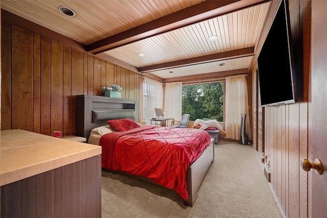 carpeted bedroom with beamed ceiling, wood ceiling, and wood walls