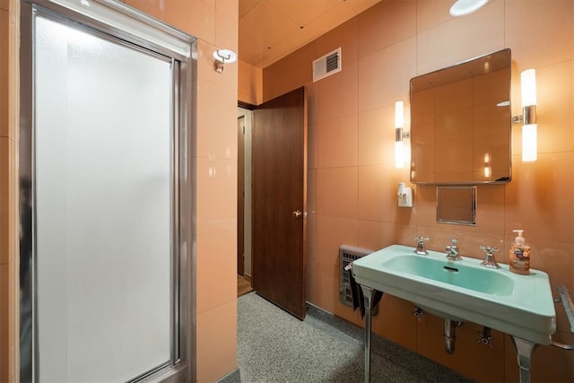 bathroom with tile walls and walk in shower