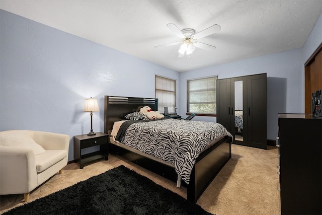 bedroom with light carpet and ceiling fan