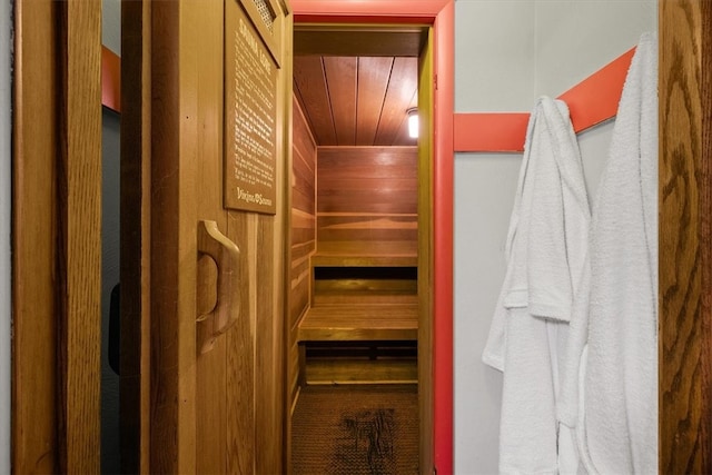 view of sauna / steam room featuring wood walls and wooden ceiling