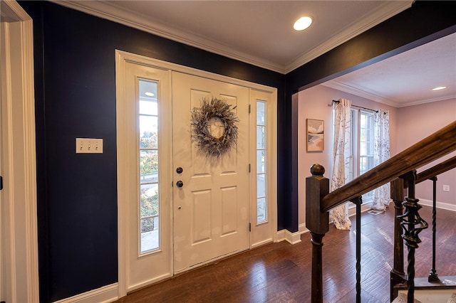 foyer entrance with crown molding and dark hardwood / wood-style flooring