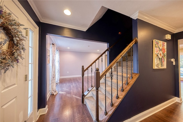 staircase featuring crown molding and wood-type flooring