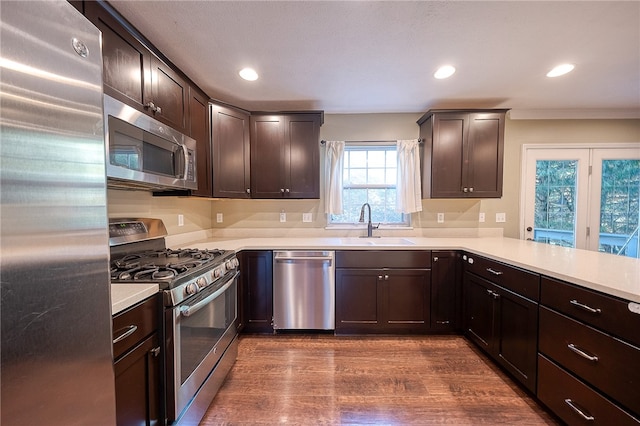 kitchen with sink, dark wood-type flooring, dark brown cabinetry, and stainless steel appliances