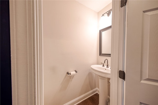 bathroom with hardwood / wood-style floors and sink