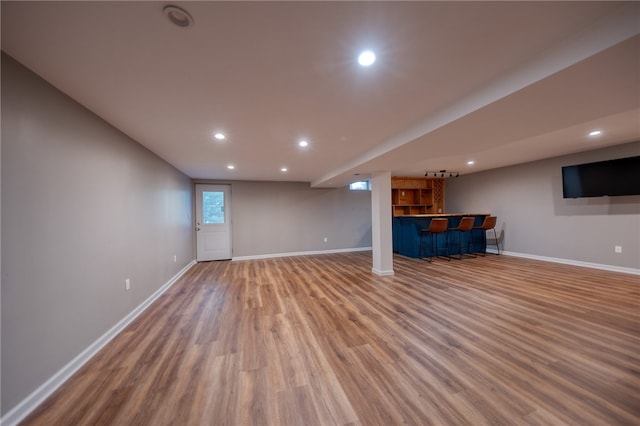 interior space with wood-type flooring and indoor bar