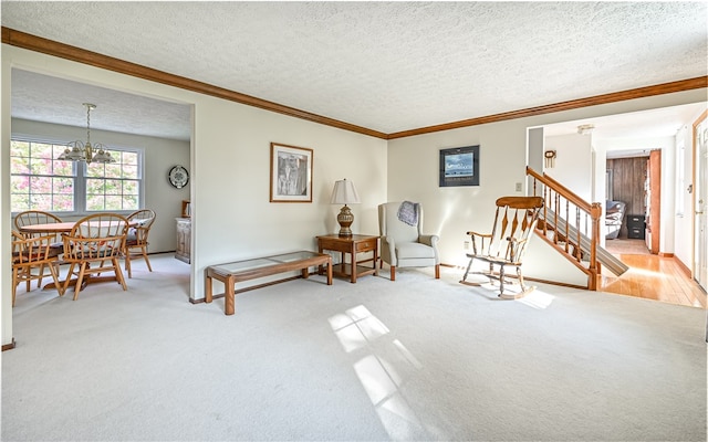 living area featuring light carpet, a notable chandelier, a textured ceiling, and crown molding