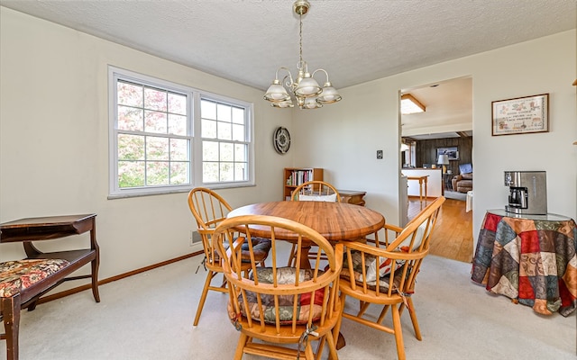 dining area with an inviting chandelier, a textured ceiling, and hardwood / wood-style flooring