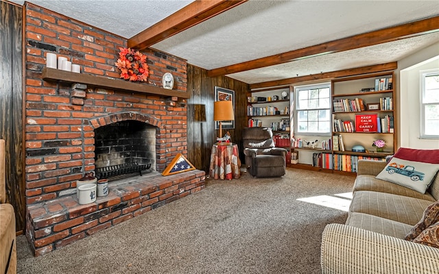 carpeted living room with a textured ceiling, a brick fireplace, plenty of natural light, and beamed ceiling