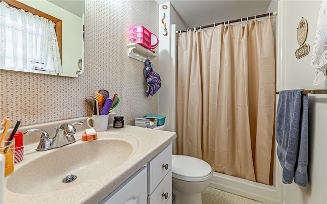 bathroom with vanity, a shower with shower curtain, and toilet