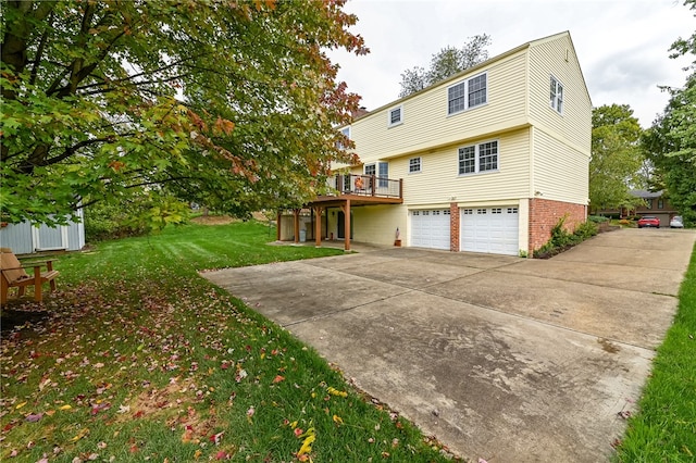 rear view of property featuring a garage and a lawn