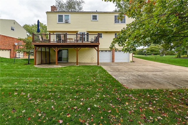 rear view of property with a wooden deck, a garage, and a lawn