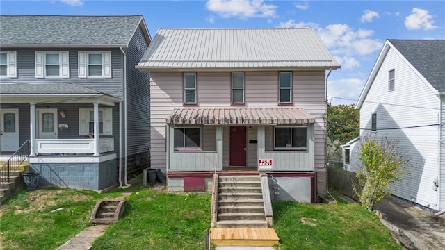 view of front facade with a front yard and a porch