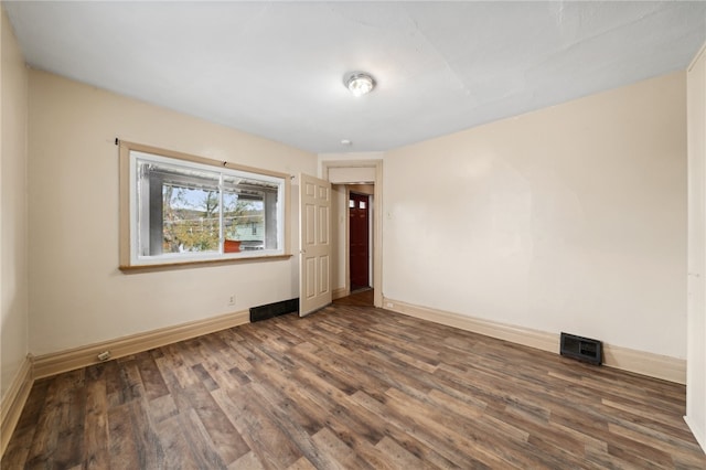 spare room with dark hardwood / wood-style floors