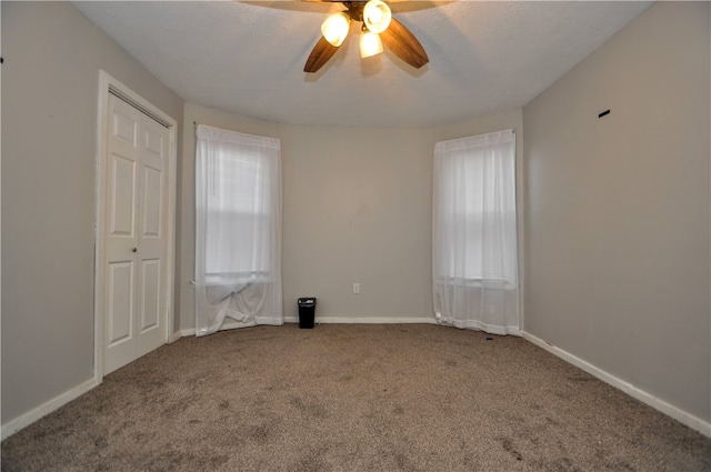 empty room featuring carpet floors and ceiling fan