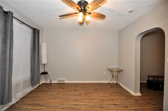 unfurnished room featuring a textured ceiling, wood-type flooring, and ceiling fan