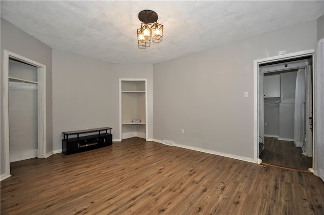 unfurnished bedroom with a textured ceiling and hardwood / wood-style floors