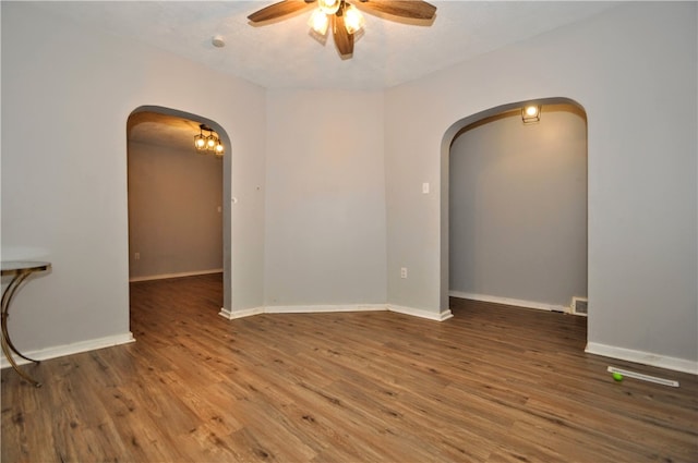 empty room featuring dark hardwood / wood-style floors and ceiling fan