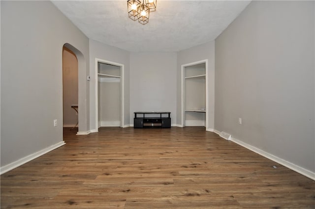 unfurnished bedroom with a textured ceiling and hardwood / wood-style flooring