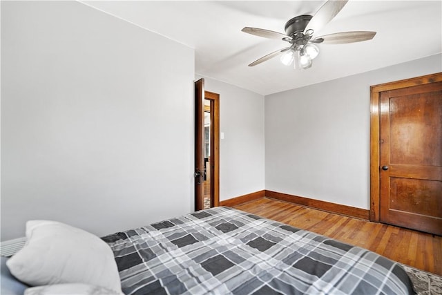 bedroom with wood-type flooring and ceiling fan