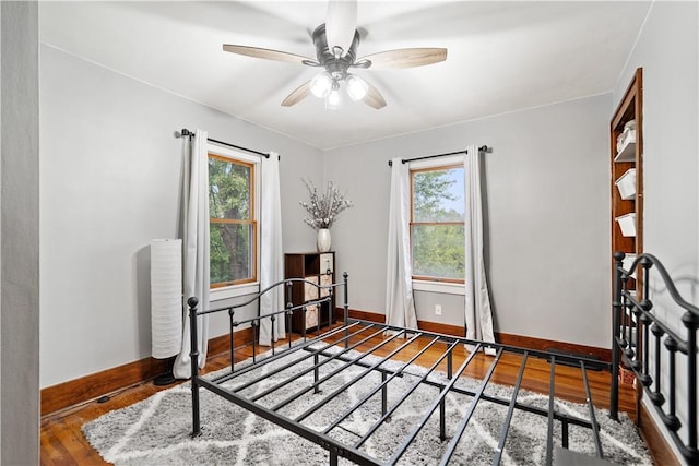 sitting room with wood-type flooring and ceiling fan