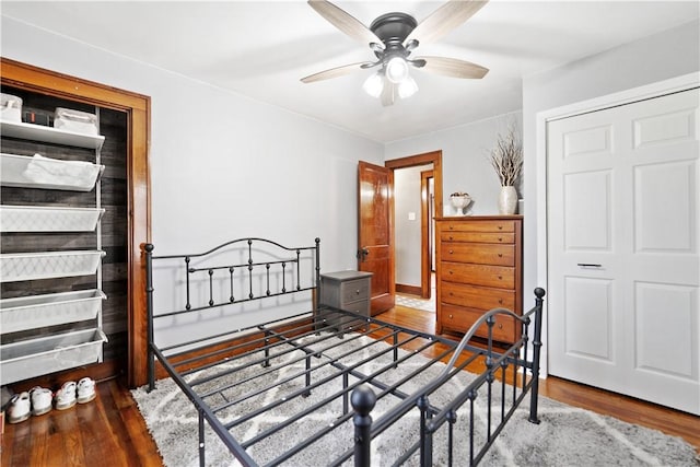 bedroom with dark hardwood / wood-style floors and ceiling fan