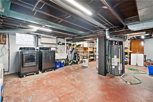 basement with washer and clothes dryer, sink, and gas water heater