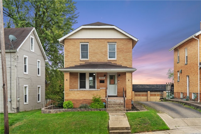 front of property featuring a yard, an outdoor structure, and a garage