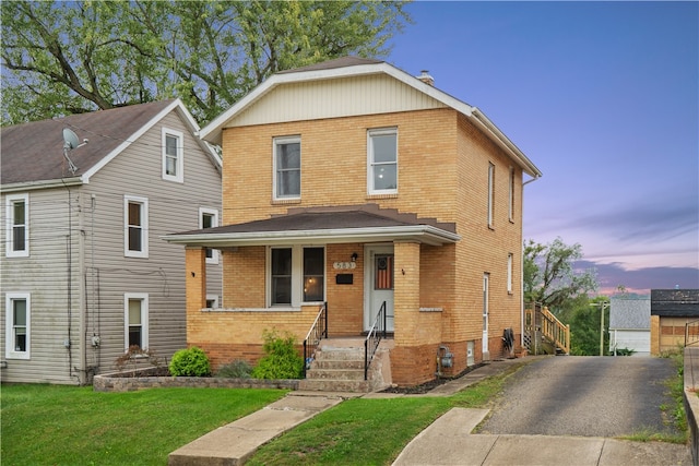 front of property featuring a garage, an outbuilding, and a yard