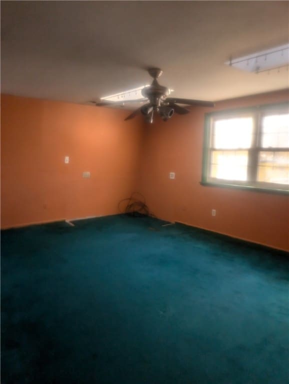 carpeted empty room with ceiling fan