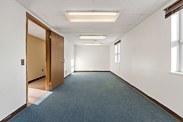 unfurnished room with dark carpet