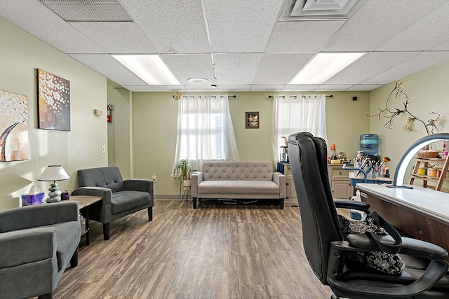 office area featuring a drop ceiling and dark hardwood / wood-style flooring