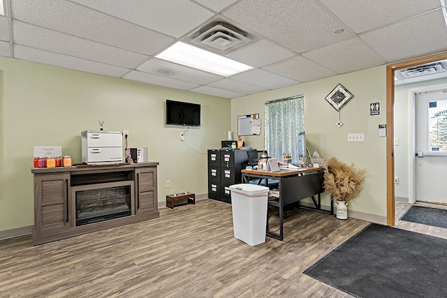 office with a drop ceiling and hardwood / wood-style flooring