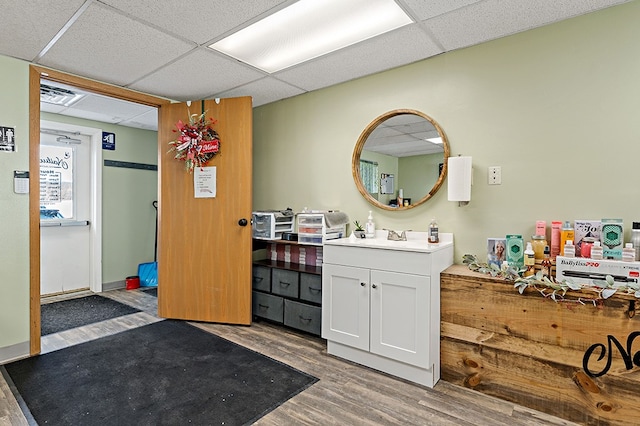 bathroom featuring vanity, a paneled ceiling, and hardwood / wood-style flooring