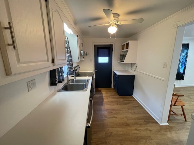 kitchen with sink, dark hardwood / wood-style floors, crown molding, extractor fan, and white cabinets