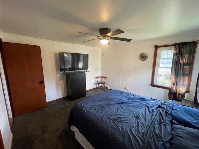 bedroom with ceiling fan and dark carpet