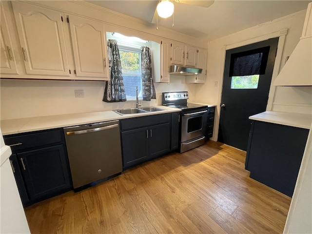 kitchen featuring white cabinetry, sink, ceiling fan, stainless steel appliances, and light hardwood / wood-style floors