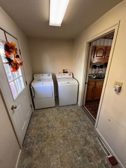 washroom with sink and washer and clothes dryer