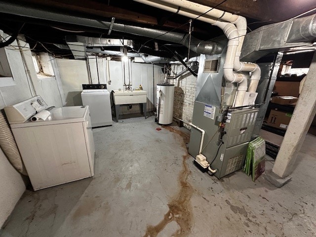 basement featuring sink, heating unit, separate washer and dryer, and gas water heater