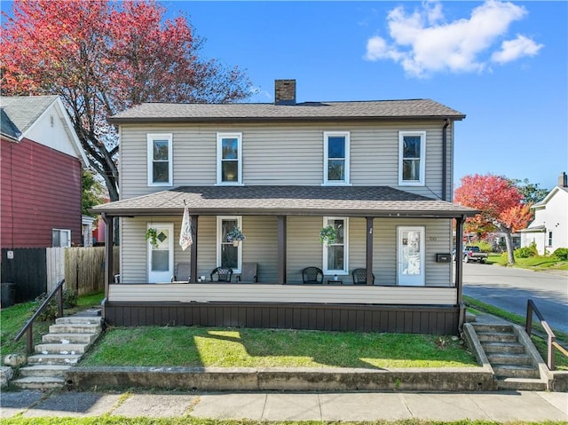 view of front of home featuring covered porch, a shingled roof, a chimney, and fence