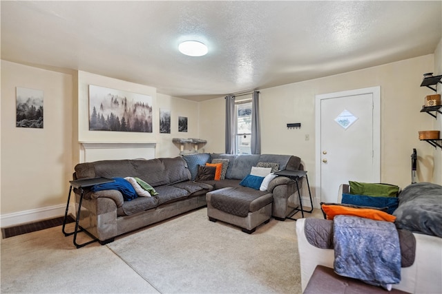 living area with baseboards and a textured ceiling