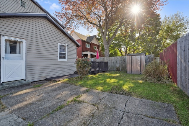 view of yard with a garage and a fenced backyard