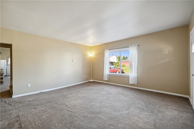 unfurnished room featuring carpet and baseboards